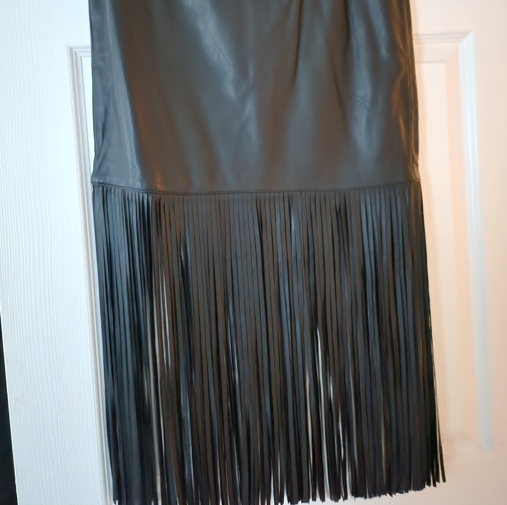Black faux leather fringed skirt size small.